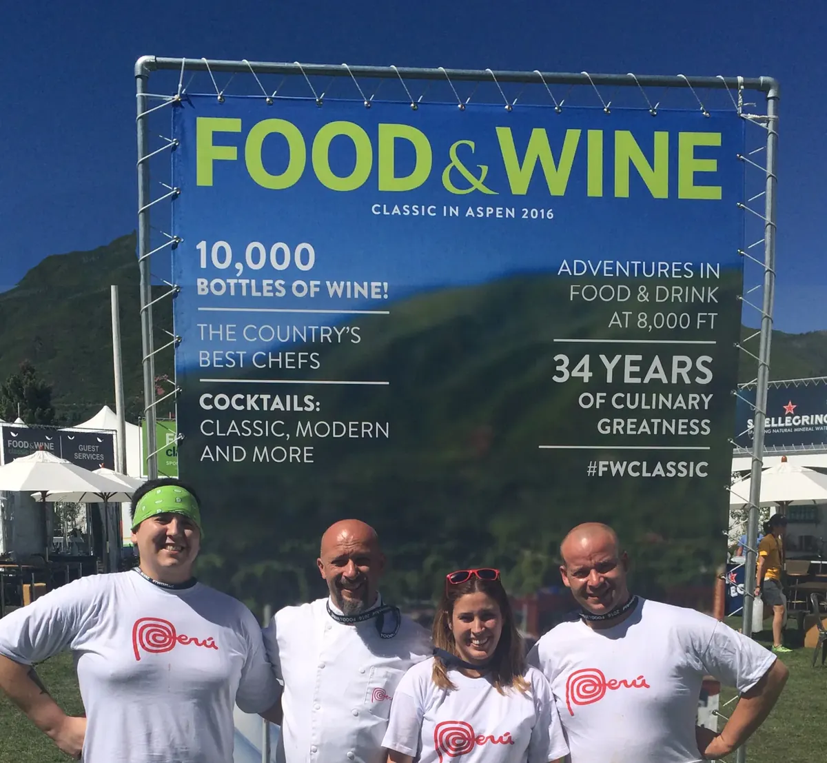Four people in Perú shirts in front of the Food & Wine Classic in Aspen 2016 banner
